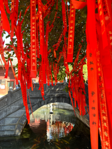 Yangshuo bridge with red banners.